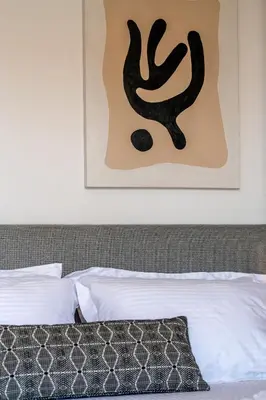 a bedroom with a bed and a picture on the wall at Glyfada Aelia Prestige in Athens
