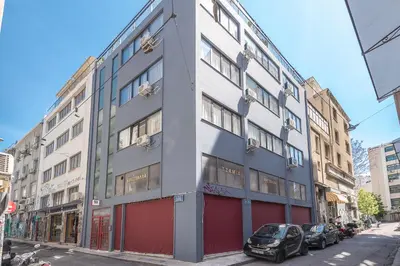 a building with cars parked in front of it on a street at Peaceful Couples Apartment & Rooftop Access - Zen Hebe By Tessera in Athens