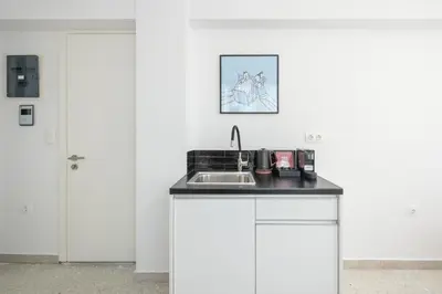 a kitchen with a sink and a counter top at Peaceful Couples Apartment & Rooftop Access - Zen Hebe By Tessera in Athens