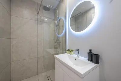 a white bathroom with a sink and a mirror at Urban Getaway Cozy Open Space & Rooftop Lounge Zen Artemis By Tessera in Athens