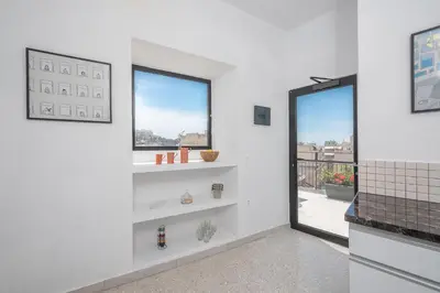 a room with white walls and windows with shelves at Urban Getaway Cozy Open Space & Rooftop Lounge Zen Artemis By Tessera in Athens