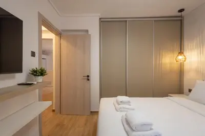 a bedroom with a bed with towels on it at The Secret Garden Stay in Athens