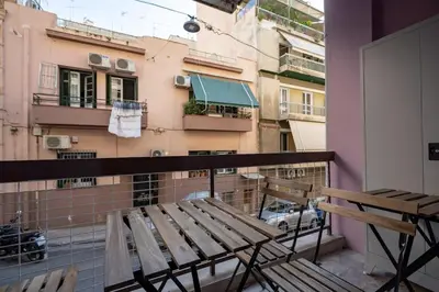 a balcony with a bench and a view of a city at Clio 3BR apartment in Kypseli by ΜΡS in Athens