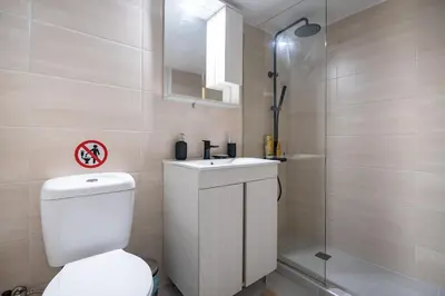 a bathroom with a toilet and a sink and a shower at Clio 3BR apartment in Kypseli by ΜΡS in Athens