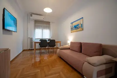 a living room with a couch and a table at Clio 3BR apartment in Kypseli by ΜΡS in Athens