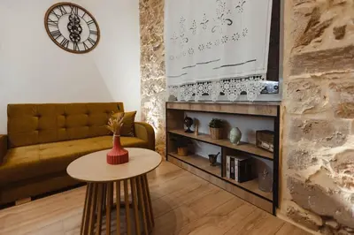 a living room with a table and a couch at Irida apartment in Athens