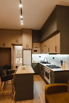 a kitchen with wooden cabinets and a stove top oven at Irida apartment in Athens