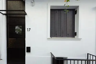 a black door on a white building with a window at Irida apartment in Athens