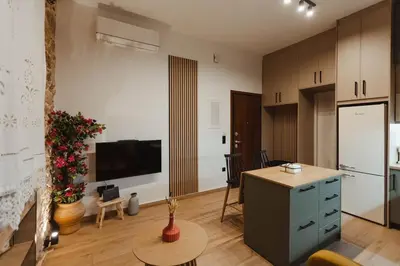 a living room with a table and a kitchen at Irida apartment in Athens