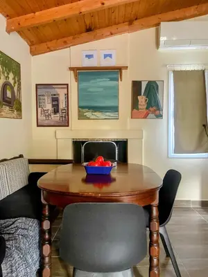 a dining room table with a bowl of fruit on it at The Simple Space, a pause near the sea in Ayía Paraskeví
