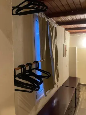 a kitchen with a bunch ofaments hanging on the wall at The Simple Space, a pause near the sea in Ayía Paraskeví