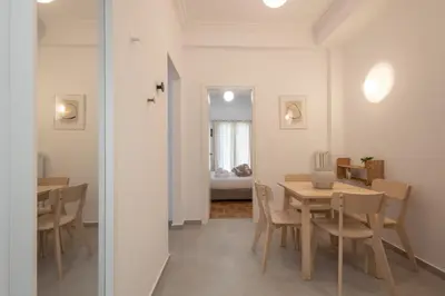 a dining room with a table and chairs at Fresh 2 bdrm Apt in Koukaki in Athens