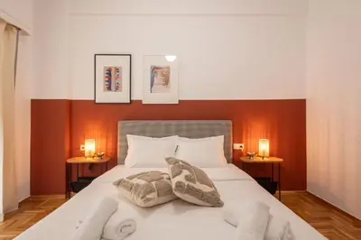 a bedroom with a bed with towels on it at Fresh 2 bdrm Apt in Koukaki in Athens