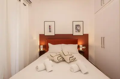 a bedroom with a bed with towels on it at Fresh 2 bdrm Apt in Koukaki in Athens