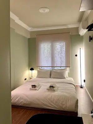 a bedroom with a large white bed with a window at Aura, Sis Urban Apartments III in Athens