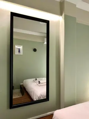 a mirror in a room with a bed in it at Aura, Sis Urban Apartments III in Athens