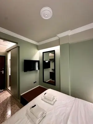 a bedroom with a bed with two towels on it at Aura, Sis Urban Apartments III in Athens