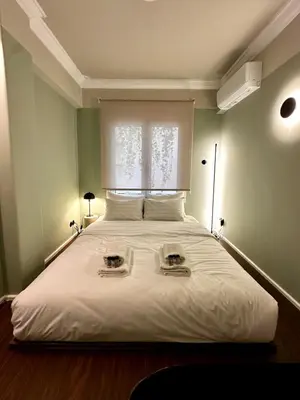 a bedroom with a large bed with a window at Aura, Sis Urban Apartments III in Athens