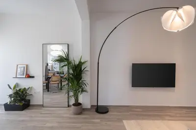 a living room with a large floor lamp and a tv at 2BD Apt in Petralona Near Metro in Athens