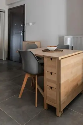 a wooden table with chairs and a bowl on it at Athenian Central Escape in Athens