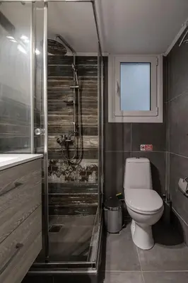 a bathroom with a toilet and a glass shower at Athenian Central Escape in Athens