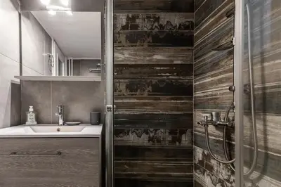 a bathroom with a sink and a wooden wall at Athenian Central Escape in Athens