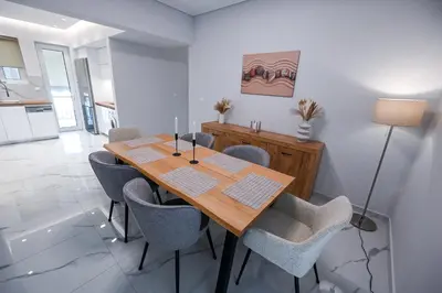 a dining room with a wooden table and chairs at Koukaki Modern Living in Athens