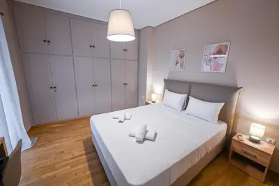 a bedroom with a bed with two candles on it at Koukaki Modern Living in Athens