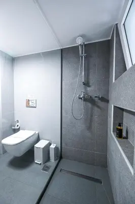 a bathroom with a shower with a toilet and a sink at Koukaki Modern Living in Athens