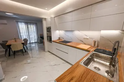 a kitchen with a sink and a table in it at Koukaki Modern Living in Athens