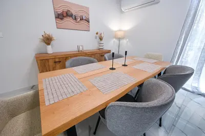 a dining room table with chairs and a wooden table at Koukaki Modern Living in Athens