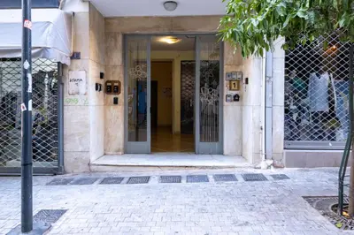 an entrance to a building with a glass door at Cozy Bright apartment next to Acropolis! in Athens