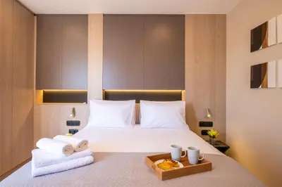 a hotel room with a bed with towels on it at Cozy Bright apartment next to Acropolis! in Athens