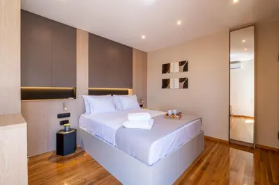 a bedroom with a large white bed with white pillows at Cozy Bright apartment next to Acropolis! in Athens