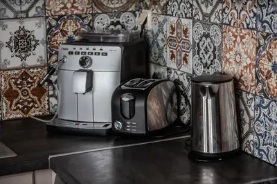 a kitchen counter with a toaster and a coffee maker at Athens Serenity in Athens