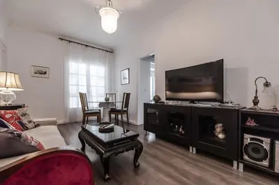 a living room with a fireplace and a tv at Athens Serenity in Athens