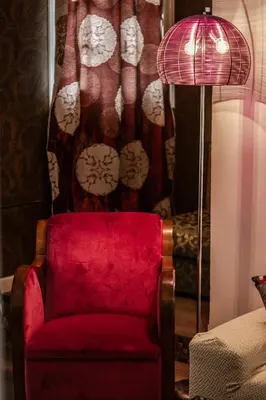 a red chair and a lamp in a room at Athens Serenity in Athens