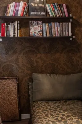 a book shelf above a bed with books on it at Athens Serenity in Athens