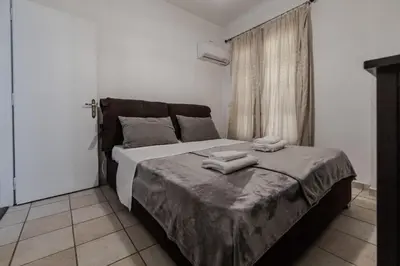 a bedroom with a bed with two towels on it at Athens Serenity in Athens