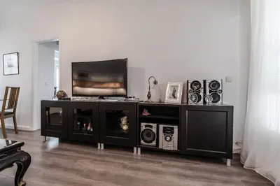 a living room with a tv and a entertainment center at Athens Serenity in Athens