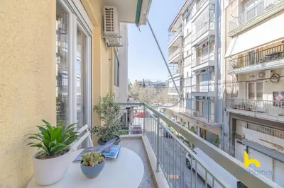 a balcony of a building with a table and plants at Bright, Central Hideaway Near Acropolis & Metro! in Athens