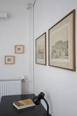 a desk with a lamp and a book on it at Spacious 3 Bedroom Apartment With Large Balcony in Athens