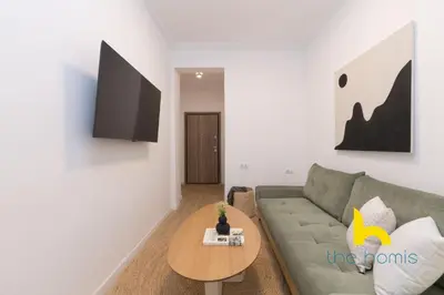 a living room with a couch and a table at Modern Athens Stay - 2BR with Balcony, Steps to Metro in Athens