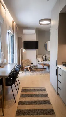 a kitchen and living room with a table and chairs at Stylish apartment with large terrace in Athens