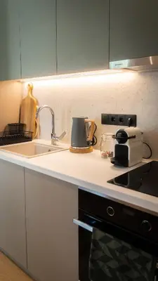 a kitchen counter with a sink and a stove at Stylish apartment with large terrace in Athens