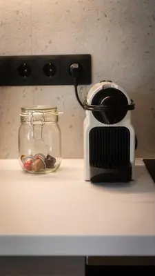 a toaster sitting on a counter next to a glass jar at Stylish apartment with large terrace in Athens
