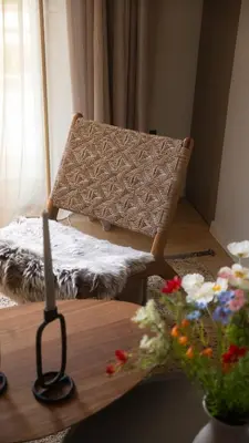 a room with a bench and a table with flowers at Stylish apartment with large terrace in Athens