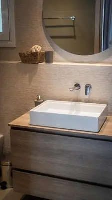 a bathroom with a white sink and a mirror at Stylish apartment with large terrace in Athens