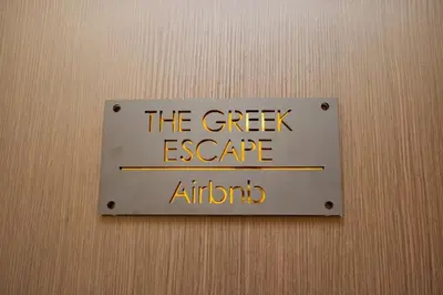 a sign on a wall that reads the greek escape at Two Bedroom Flat In Athens in Athens
