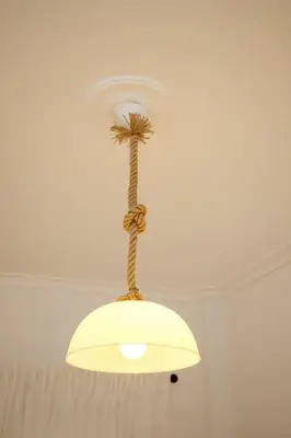 a light hanging from a ceiling with a plant on it at Two Bedroom Flat In Athens in Athens